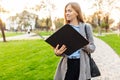 young business woman standing in a park with a folder and looking into it Royalty Free Stock Photo