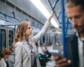 Young business woman standing in a subway train. Royalty Free Stock Photo