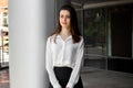 Young business woman stands across a businesscenter and looks as Royalty Free Stock Photo