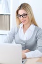 Young business woman or student girl sitting at office workplace with laptop computer. Home business concept Royalty Free Stock Photo