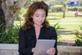 Young business woman with tablet computer on a park bench Royalty Free Stock Photo