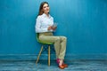 Young business woman with tablet sitting on chair. Royalty Free Stock Photo