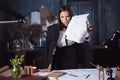 Young business woman throwing documents at camera. Royalty Free Stock Photo