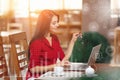 Young business woman uses laptop in cafe Royalty Free Stock Photo