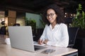 Young business woman using laptop computer at office, Student girl working at modern workspace.