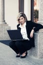 Young business woman using laptop at office building Royalty Free Stock Photo