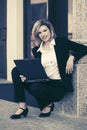 Young business woman using laptop at office building Royalty Free Stock Photo