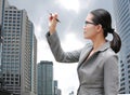 Young Business woman using pen writing on air against building background, Business Concept Royalty Free Stock Photo