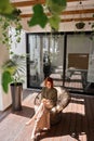 Young business woman using phone sitting in sunny office. Vertical top view Royalty Free Stock Photo