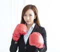 Business woman wearing boxing gloves ready to fight Royalty Free Stock Photo