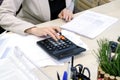 Young business woman working hard over the Desk in the study, economist accountant financial reporting, verifies accuracy of docum Royalty Free Stock Photo