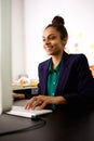 Young business woman working at her desk and smiling Royalty Free Stock Photo