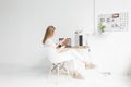 Young business woman working at home and reading a book. Creative Scandinavian style workspace