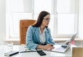 Young business woman working on laptop