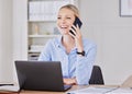 Young business woman working in modern office, making phone call while sitting in front of her laptop. Female Royalty Free Stock Photo