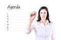 Young business woman writing blank agenda list. Royalty Free Stock Photo