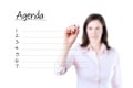 Young business woman writing blank agenda list. Royalty Free Stock Photo