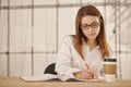 Young business woman writing in office Royalty Free Stock Photo