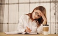 A young business woman writing in office. Royalty Free Stock Photo