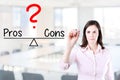 Young business woman writing pros and cons compare on balance bar. Office background.