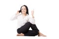 Young business woman in yoga pose talking on mobile phone on white background Royalty Free Stock Photo