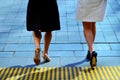 Young business women legs walking on city street together. Royalty Free Stock Photo