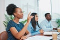 Young business woman raises hand in boardroom meeting to ask question Royalty Free Stock Photo