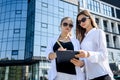 Young business woman signing contract outside business center in big city Royalty Free Stock Photo