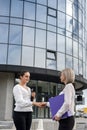Young business woman signing contract outside business center in big city Royalty Free Stock Photo