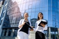 Young business woman signing contract outside business center in big city Royalty Free Stock Photo