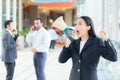 Young business woman working at the office, shouting and yelling in megaphone Royalty Free Stock Photo
