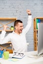 Young businessman achiving his goal and showing raised fists Royalty Free Stock Photo