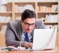 Young businessman addicted to online gambling cards playing in t Royalty Free Stock Photo