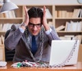 Young businessman addicted to online gambling cards playing in t Royalty Free Stock Photo