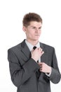 Young businessman adjusting his tie.isolated on a white Royalty Free Stock Photo