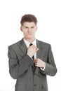 Young businessman adjusting his tie.isolated on a white Royalty Free Stock Photo