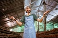 Young businessman in apron smiling at camera in chicken farm Royalty Free Stock Photo