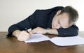 Young businessman asleep at his desktop