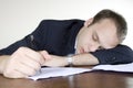 Young businessman asleep at his desktop