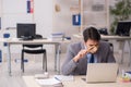 Young male employee auditor holding magnifying glass