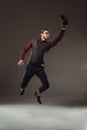 young businessman in baseball glove jumping and catching ball Royalty Free Stock Photo