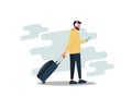 Young businessman with a beard pulling luggage busy with a mobile phone. The concept of rest. Labor balance of life. Digital nomad Royalty Free Stock Photo