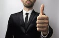 Young businessman with a beard shows a tin thumb up. Success Royalty Free Stock Photo