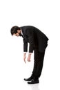 Young businessman bending down.