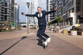 young businessman in a blue suit jumping in the air against blue sky Royalty Free Stock Photo