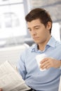 Young businessman on break reading papers Royalty Free Stock Photo