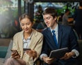 Young businessman and businesswoman shopping online via mobile phone and tablet together, payment credit card, look at mobile Royalty Free Stock Photo