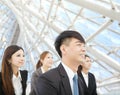 Young businessman and businesswoman stand in the modern office