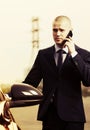 Young businessman calling on phone next to car Royalty Free Stock Photo