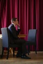 A young businessman came to lunch in a cafe, he sits at a table and waits someone